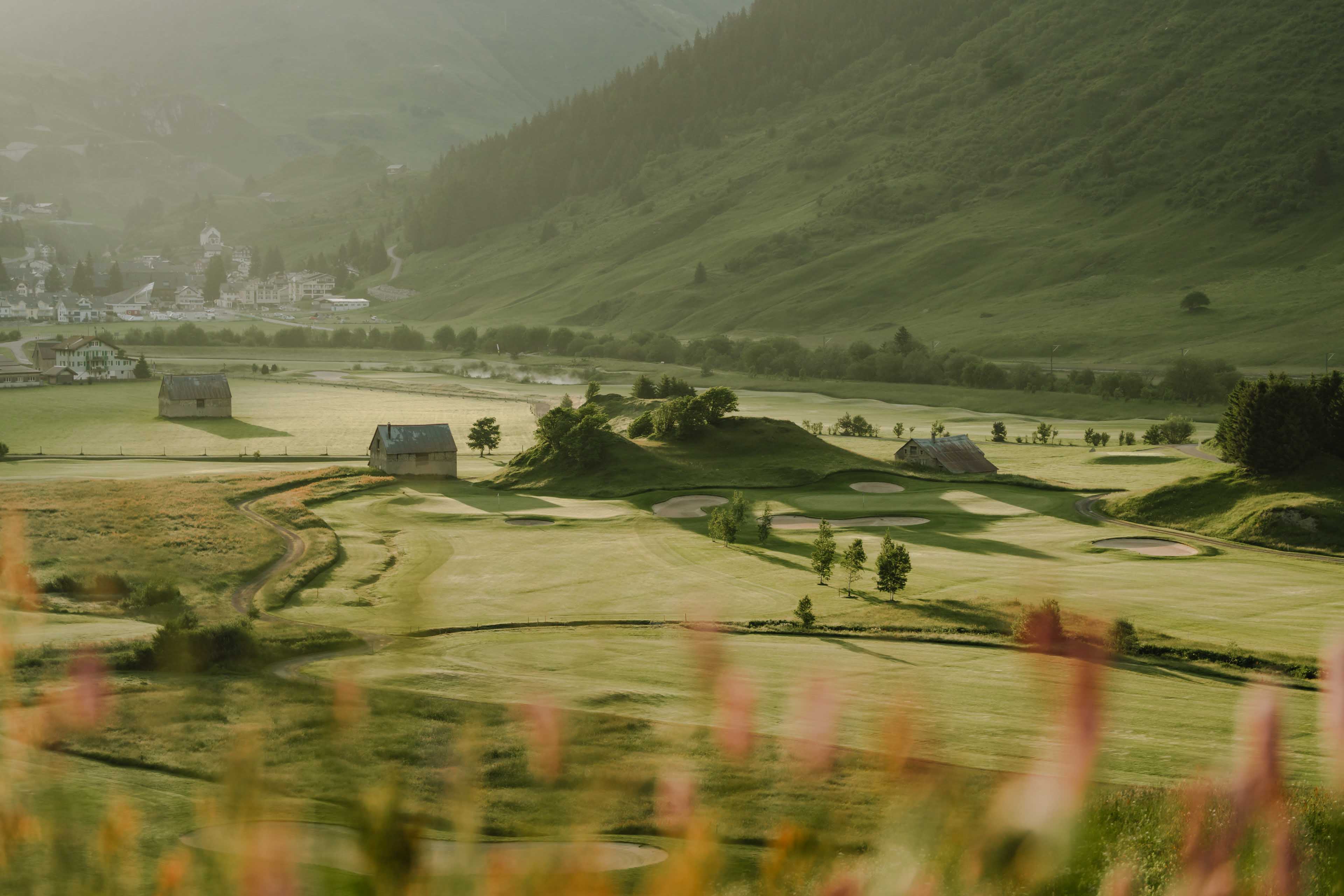 Green fields surrounding the golf course in Andermatt