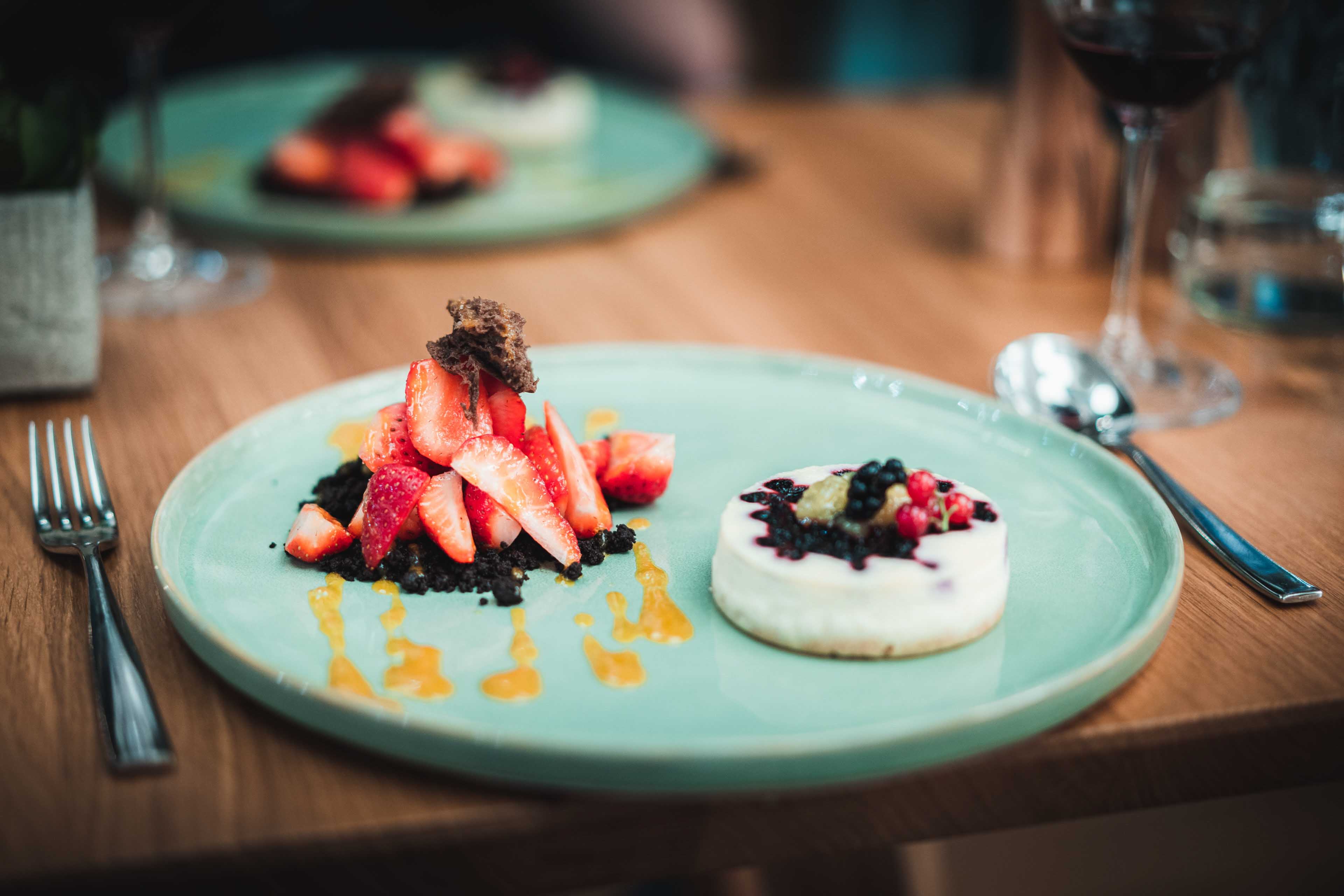 Desert dish with strawberries, cheesecake and chocolate