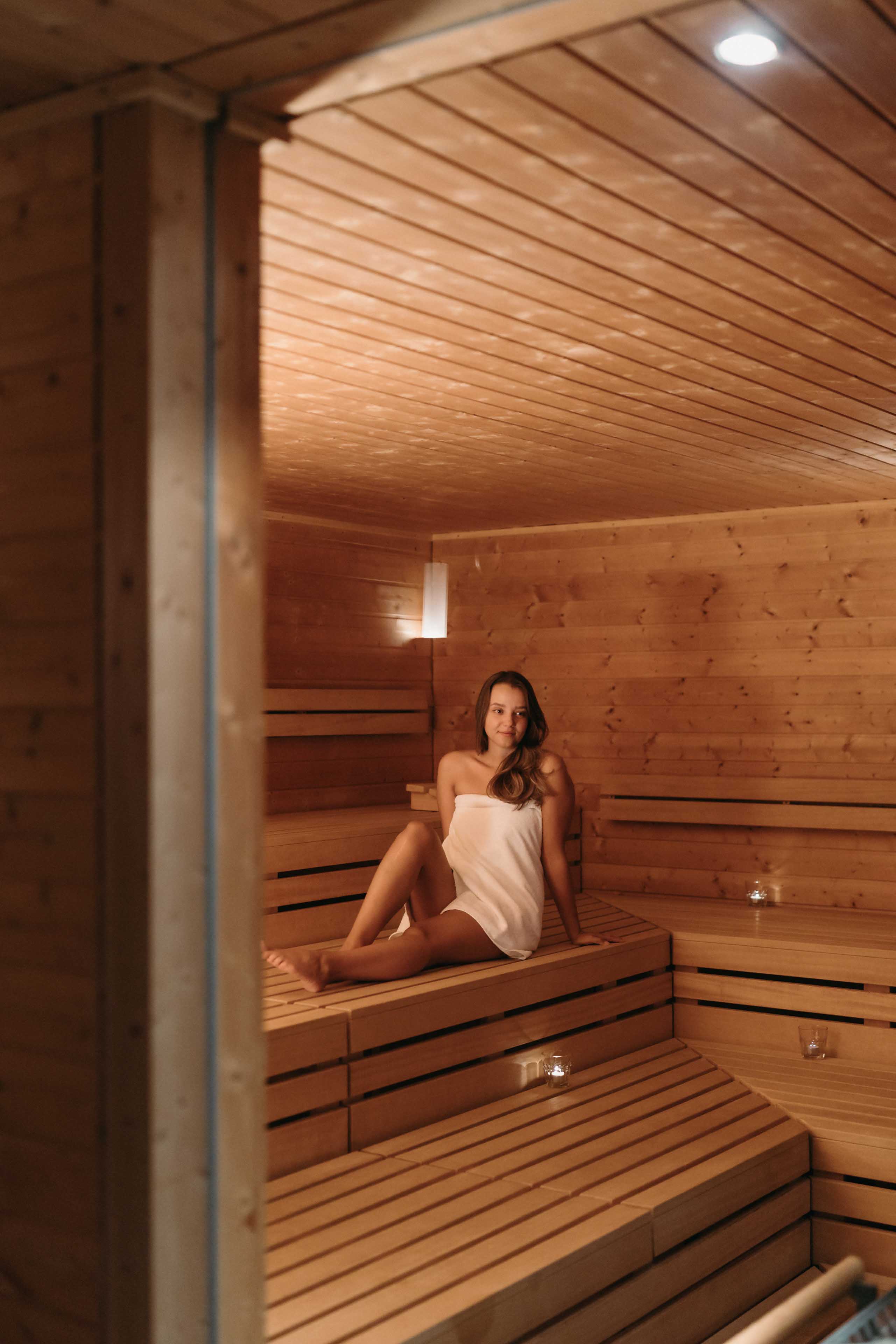 Women in the wooden sauna wider shot