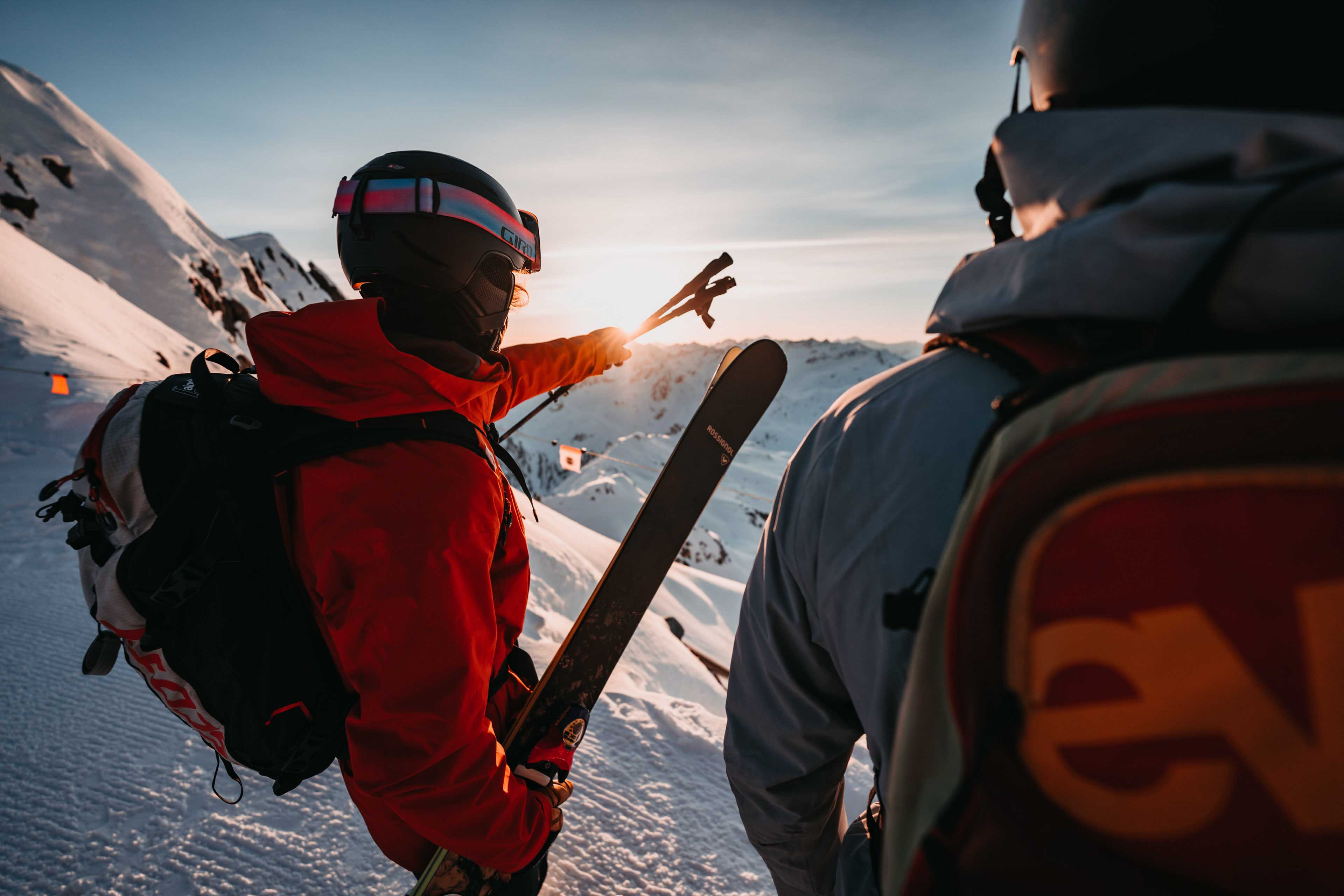 A skier and a snowboarder in the alps