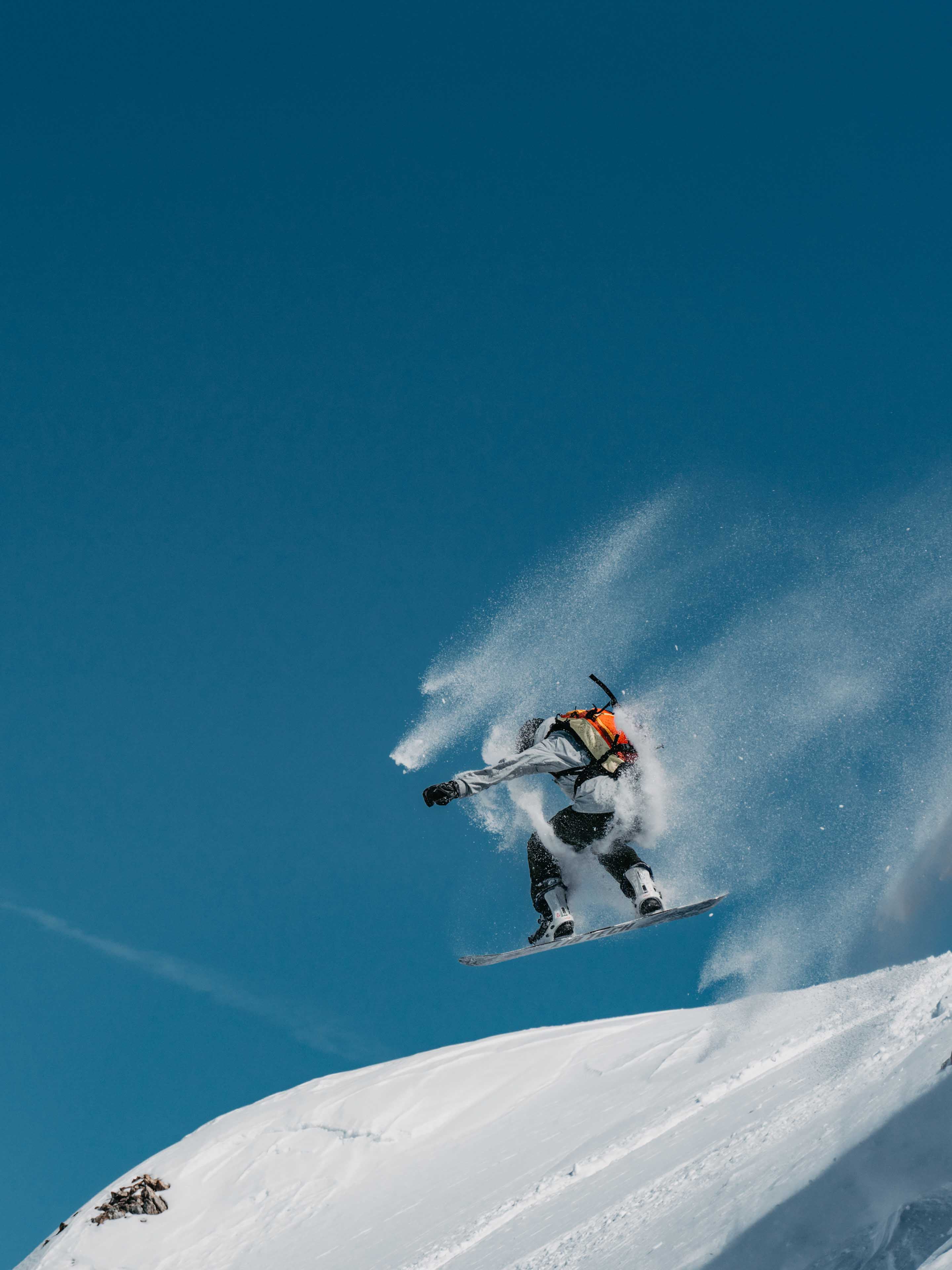 Snowboarder jumping off a cliff