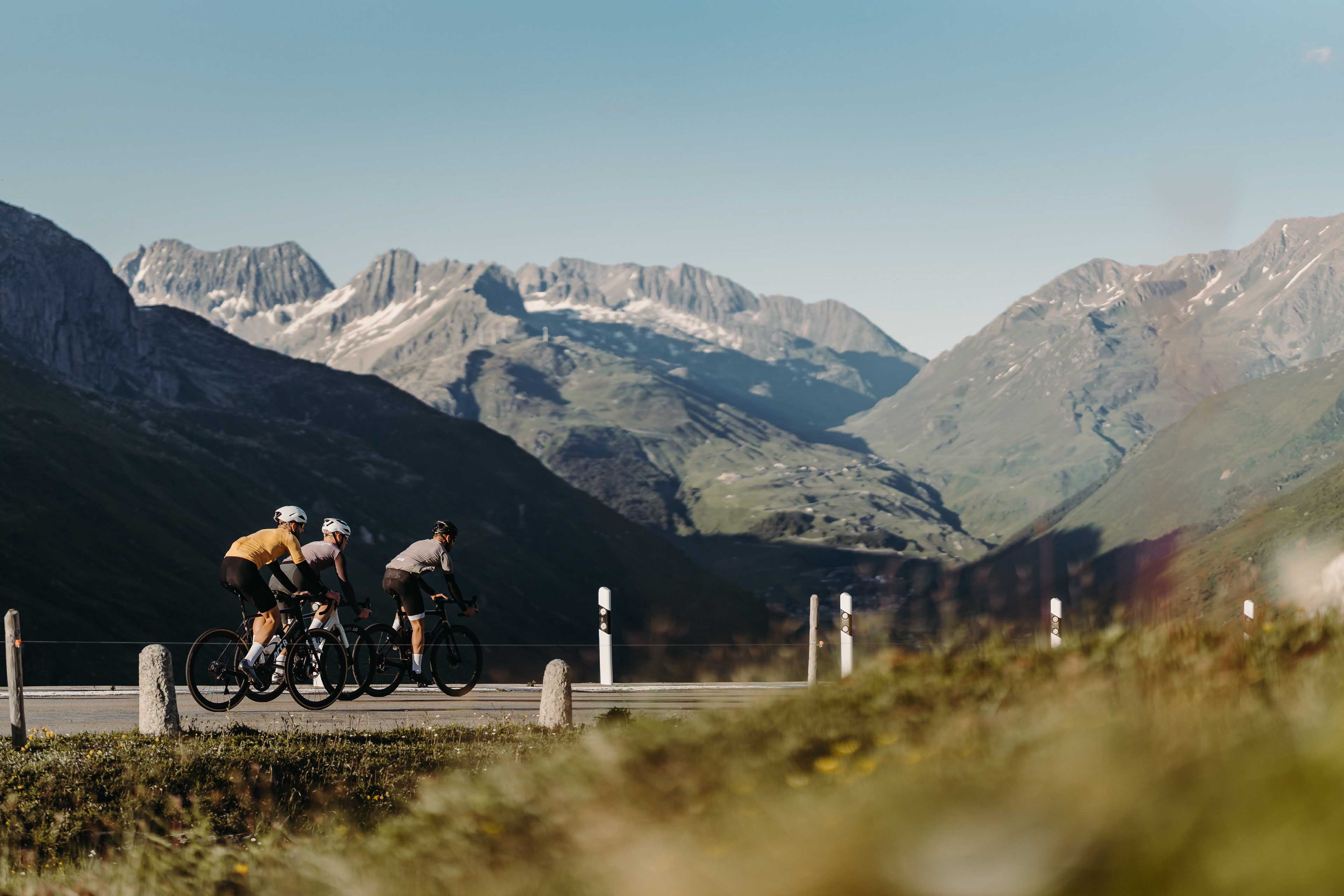 Road cyclists with Andermatt in the background