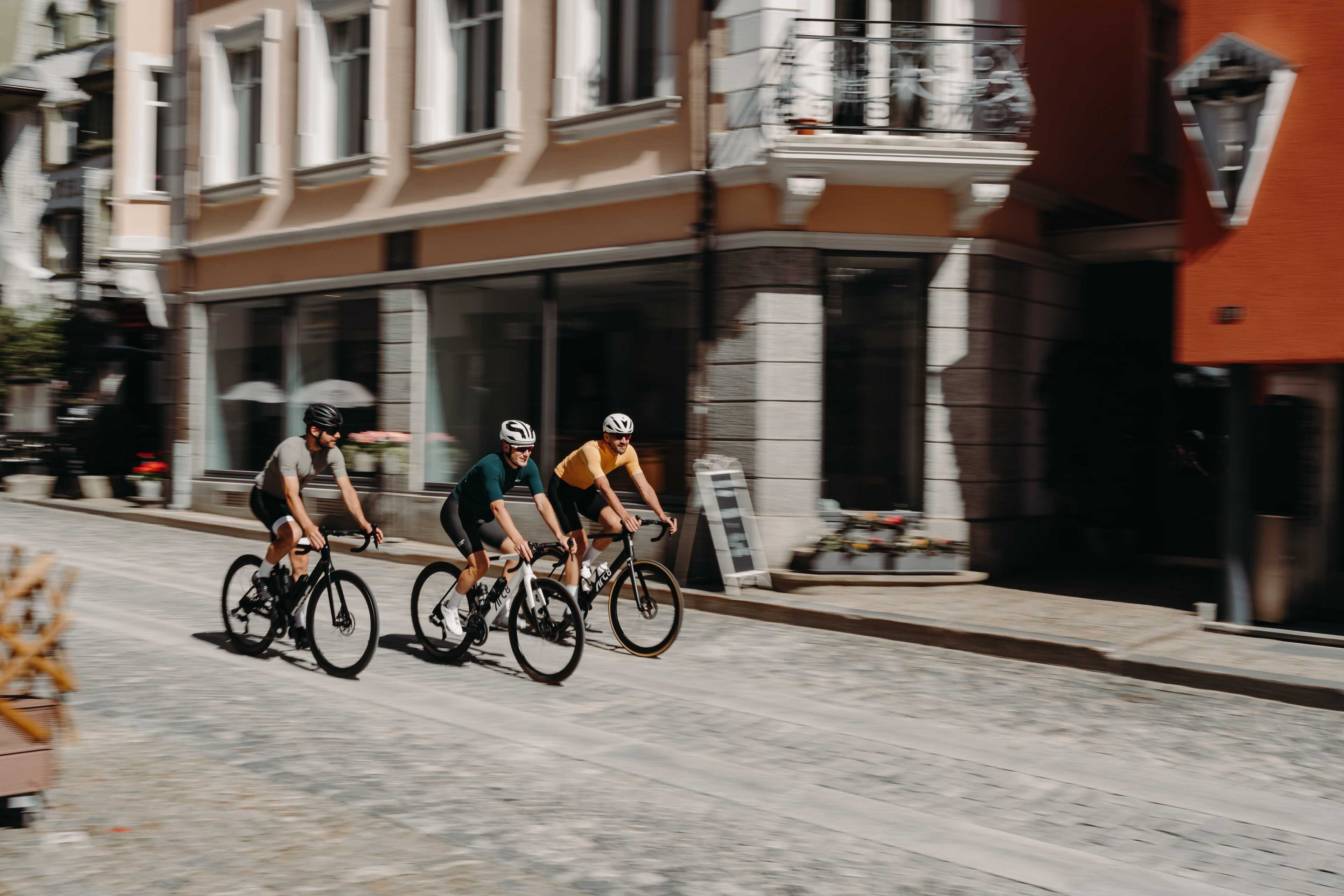 Cyclists riding through Andermatt, different angle